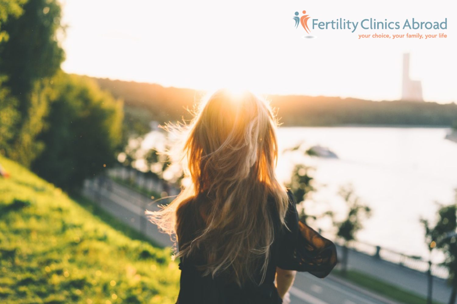 A single woman with blond long hair who is walking in the park and considering undergoing IVF